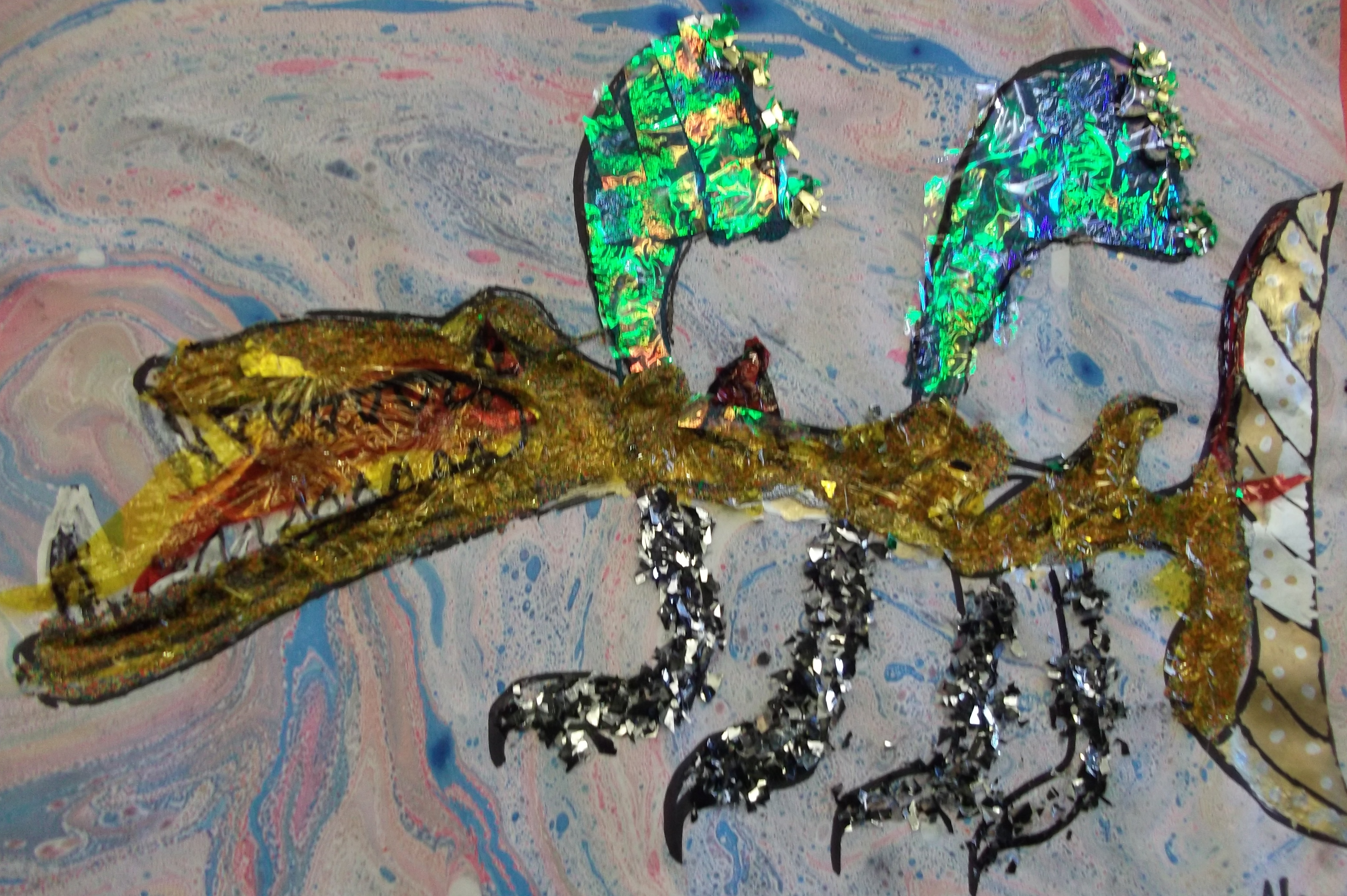 Mixed media collage of a dragon by Y4 child, inspired by Uccello's St George and the Dragon