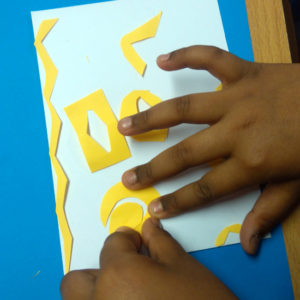 Pupil explores composition with cut out shapes and stencils