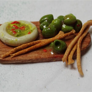 A mini meal of breadsticks, olives and guacamole