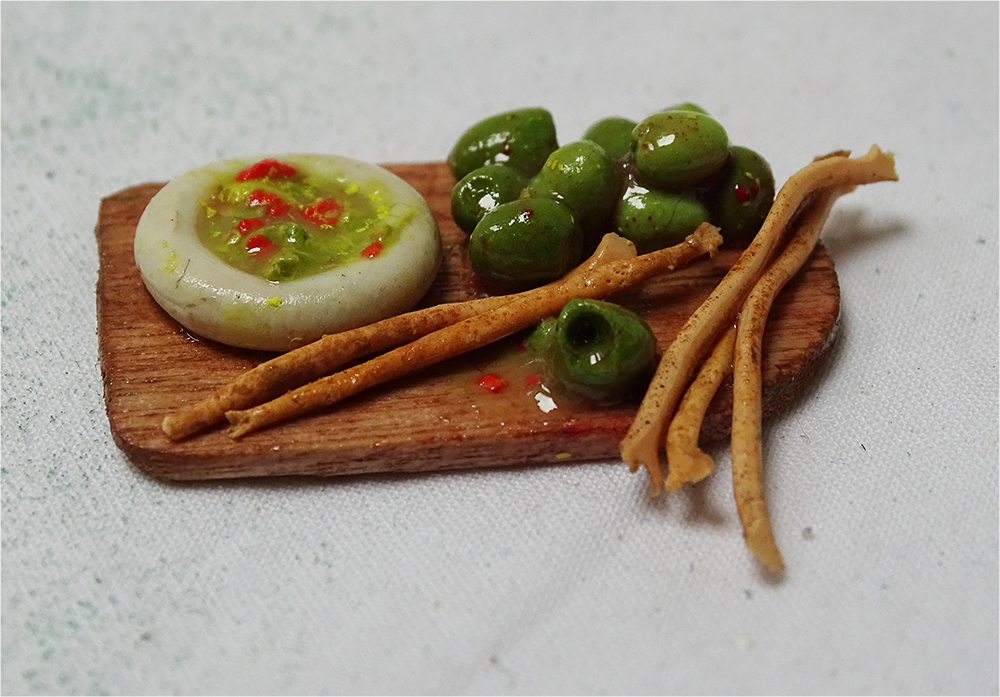 A mini meal of breadsticks, olives and guacamole