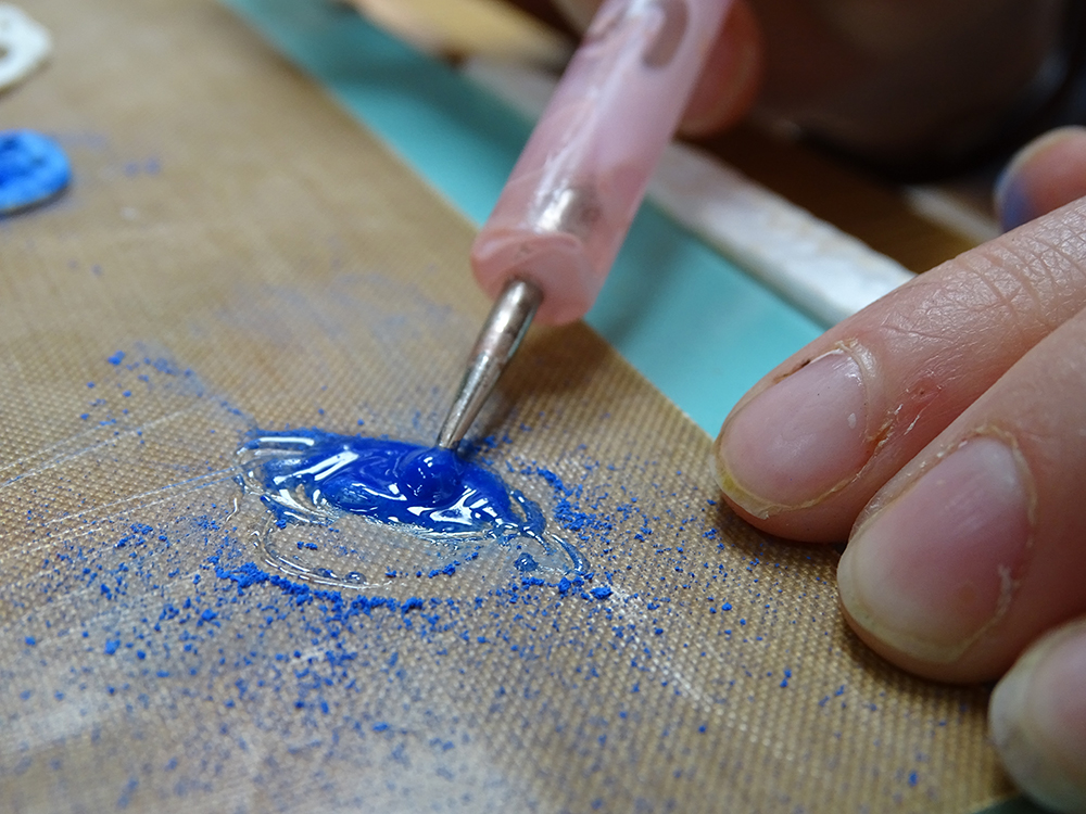 Or mixing pigment with medium to apply as paint