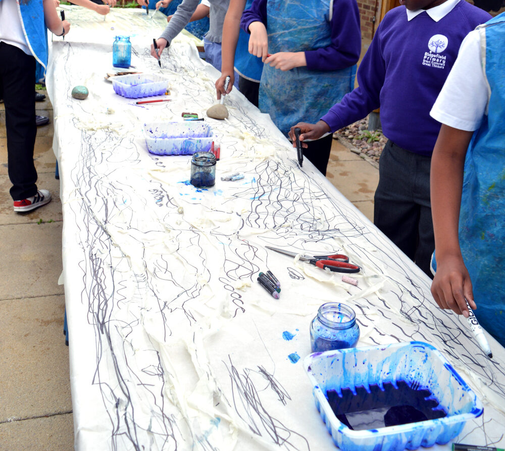 To get a sense of the length of the paper and prevent the youngsters feeling confined to one part of the sheet, they walked in procession mark making along the length and breadth of the paper