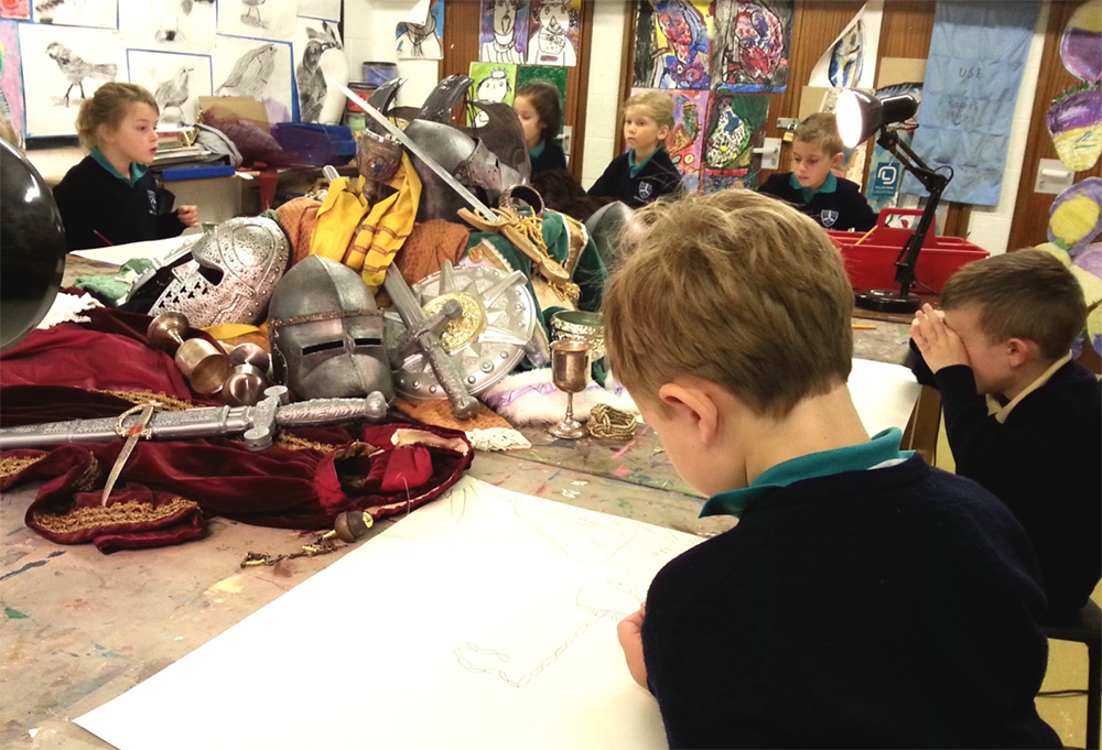 Year 3 Size-A2 Drawings. Inspired by a painting of a Saint, a still life set-up composed by pupils from drama props and using viewfinders used to focus on materials, shapes, patterns and textures.