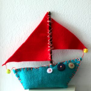 Artist educator Ruth Purdy uses colourful felt in a project sewing boats with adults in care.