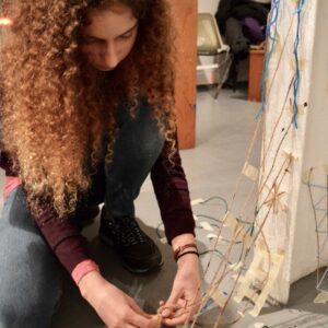 teenager, Esther, working on installation with artist Melissa Murray