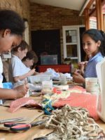 Children start work building reliefs inspired by the 'under the ocean' theme, with a variety of waste materials - SC Ridgefield