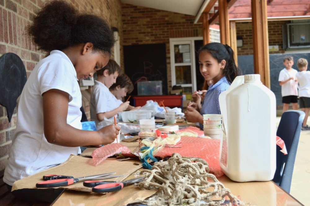 Children start work building reliefs inspired by the 'under the ocean' theme, with a variety of waste materials - SC Ridgefield