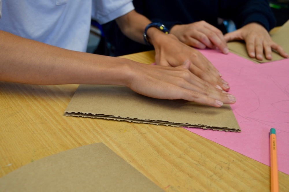 Folding brown paper to create a zigzag sketchbook 