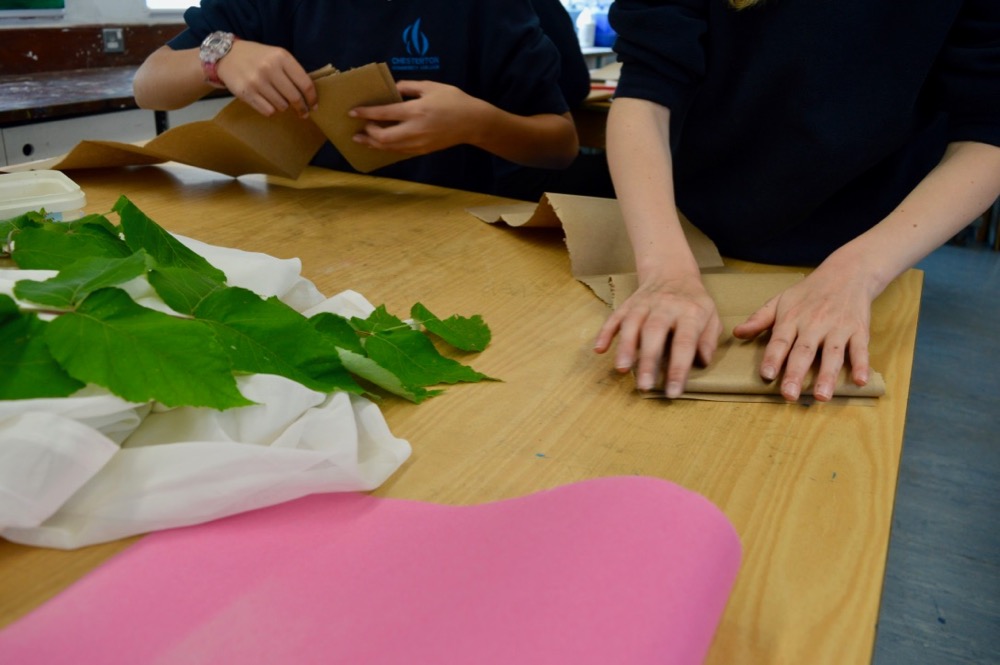 Folding brown paper to create a zigzag sketchbook 