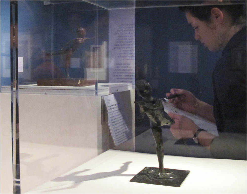 Teacher drawing from Degas sculptures: Arabesque over the Right Leg, Left Arm in Front, First Study, copper alloy C.119 (foreground) Arabesque over the Right Leg, Left Arm in Front, First Study, coloured wax, C.114 (background)