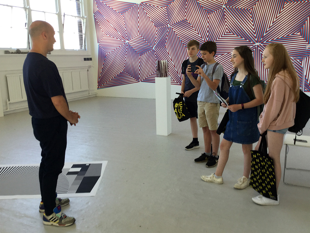 Teenagers interviewing Sculpture undergraduate at NUA