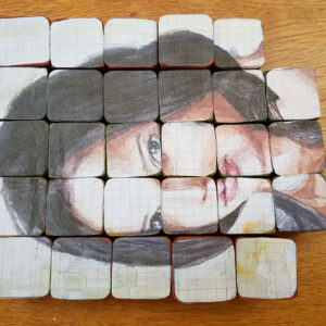 Portrait stuck on building blocks to form a puzzle
