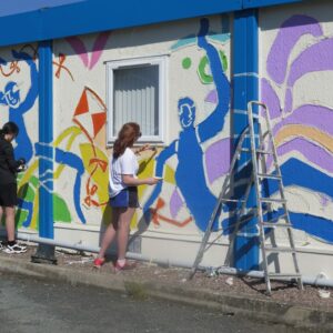 Climbing a ladder to paint