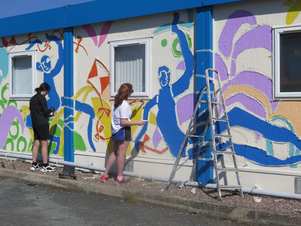 Climbing a ladder to paint
