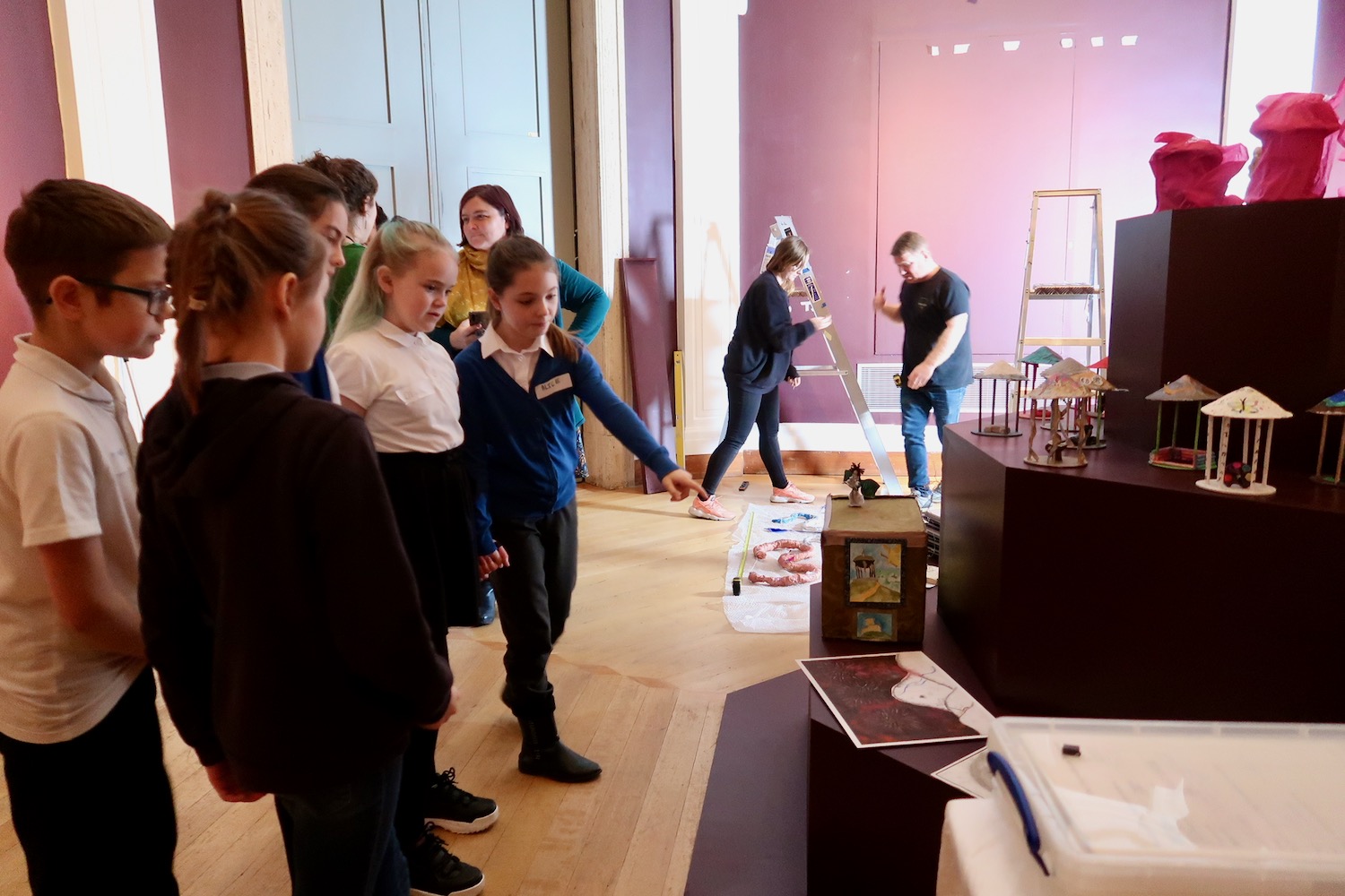 In the Octagon Gallery pupils are greeted by the installation team Charis Millett and Jamie who are installing their work