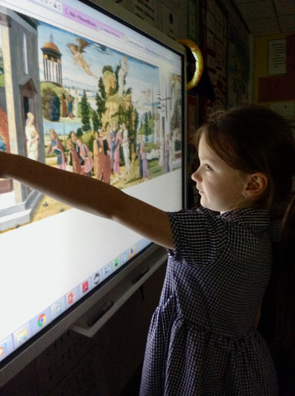 A girl looking at a painting of Cupid and Psyche on a whiteboard in a classroom