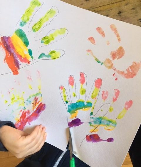 cutting out the rainbow hands