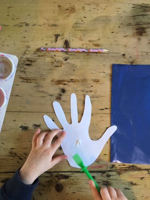 applying glue to the cut out hand