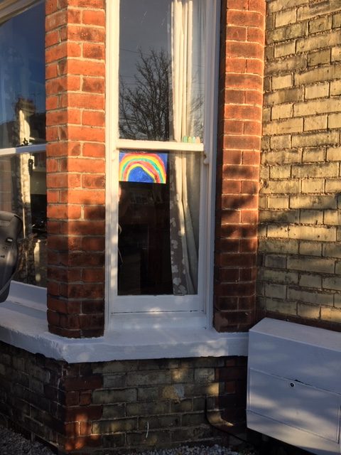 rainbow painting displayed in window