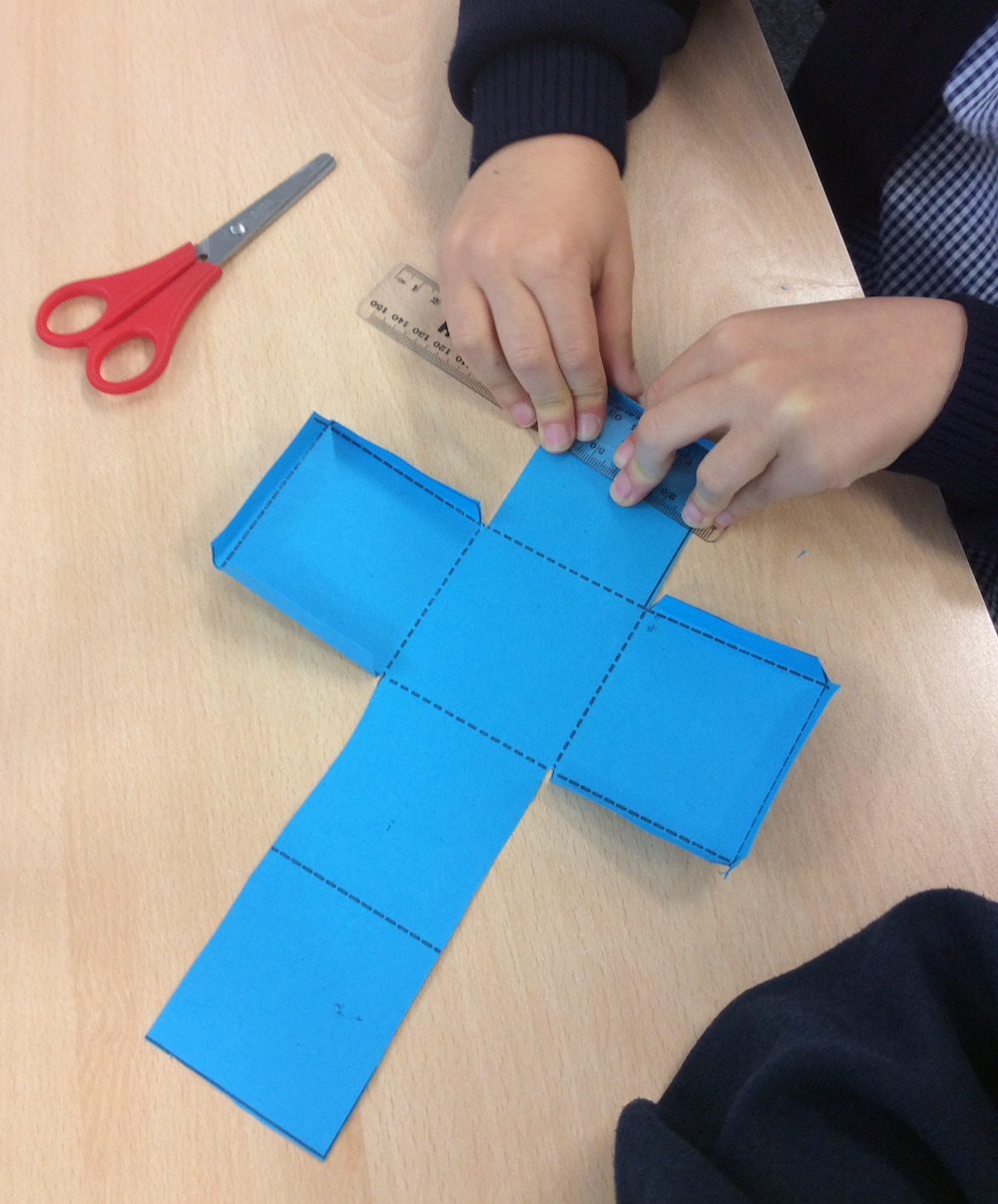 Folding a cut out net of a cube