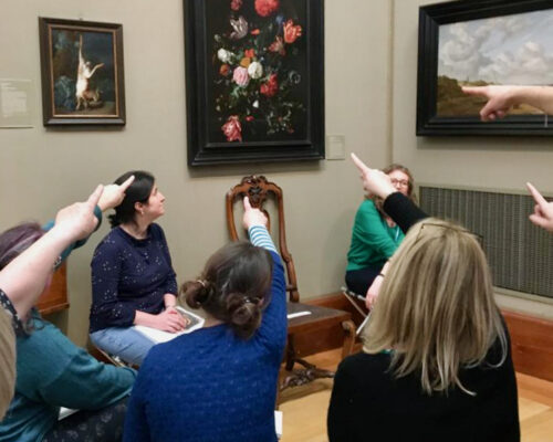 Teachers pointing at flowers in a glass vase by de Heem at the Fitzwilliam Museum, Cambridge