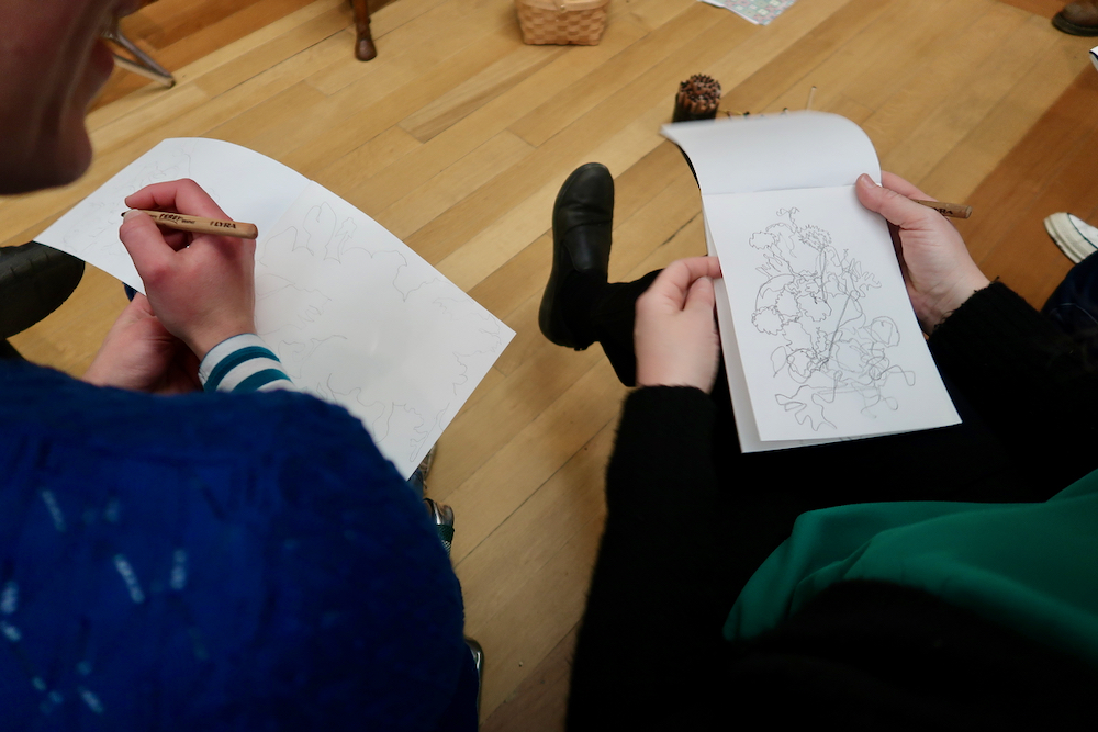 Drawing the shapes between the flowers looking at de Heem's flowers in a glass vase at the Fitzwilliam Museum, Cambridge