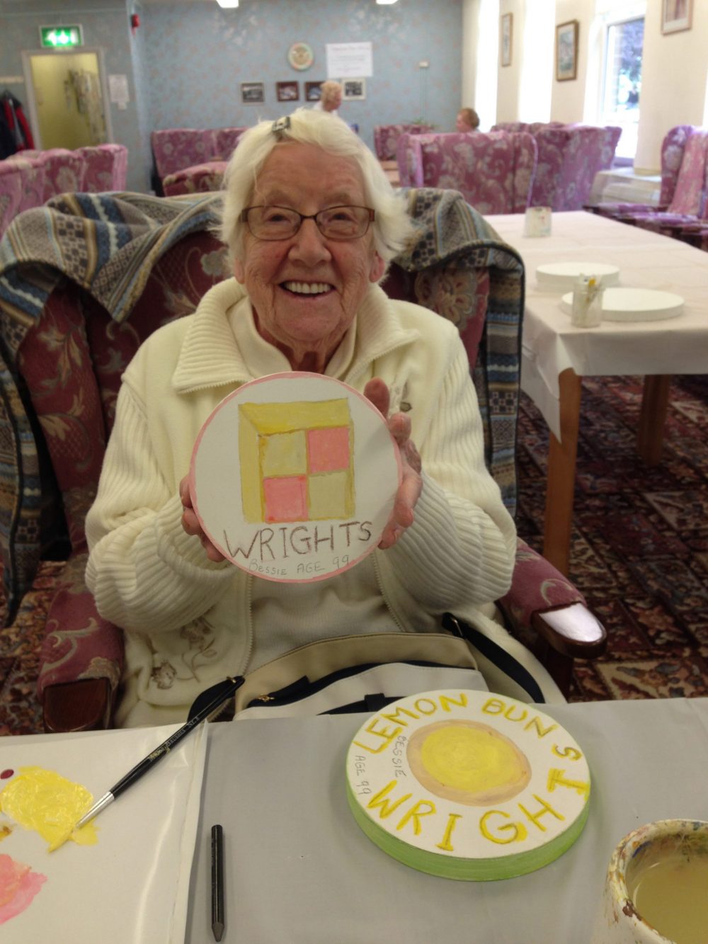 An elderly participant with her design