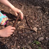 Trying to Balance Sticks by Rachel Thompson