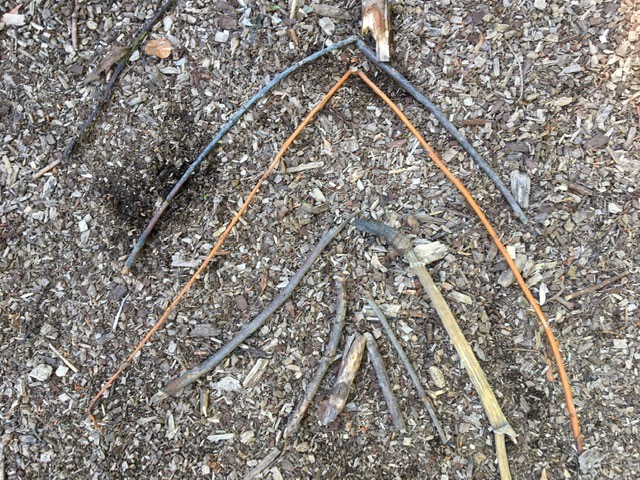 arranging twigs into a descending arrow pattern