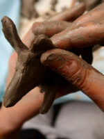 Moulding clay with wet fingers