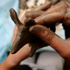 Moulding clay with wet fingers