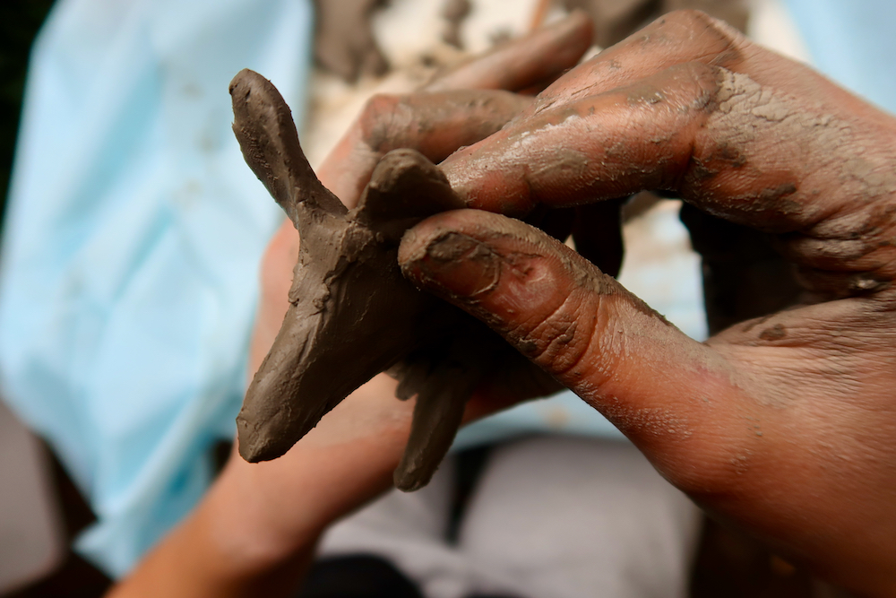 Moulding clay with wet fingers
