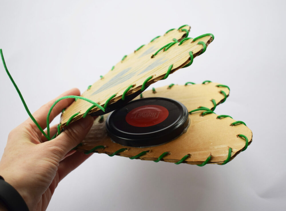 Using scrap card and a jam jar lid to create castanets
