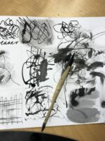 A sketchbook split into a grid with marks in each section