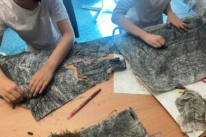 Looking at the witches in detail, and using paper manipulation to construct paper capes.