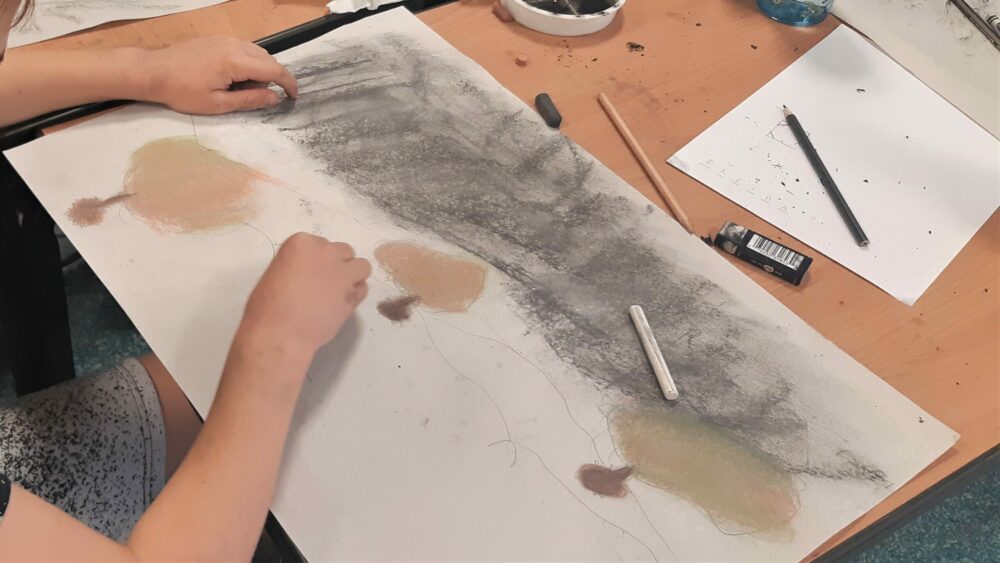 Layering pastels over charcoal.