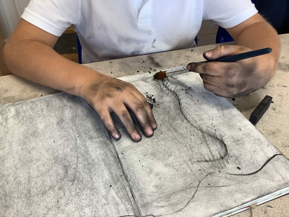 Using charcoal to experiment making marks.