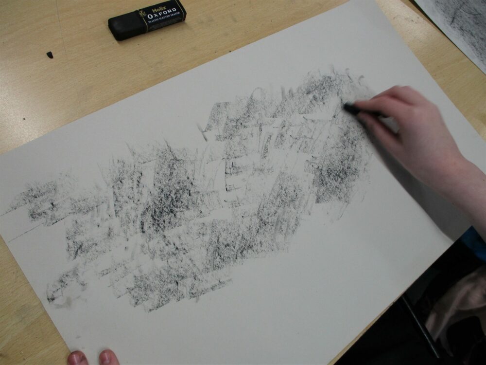 Covering a page in charcoal.