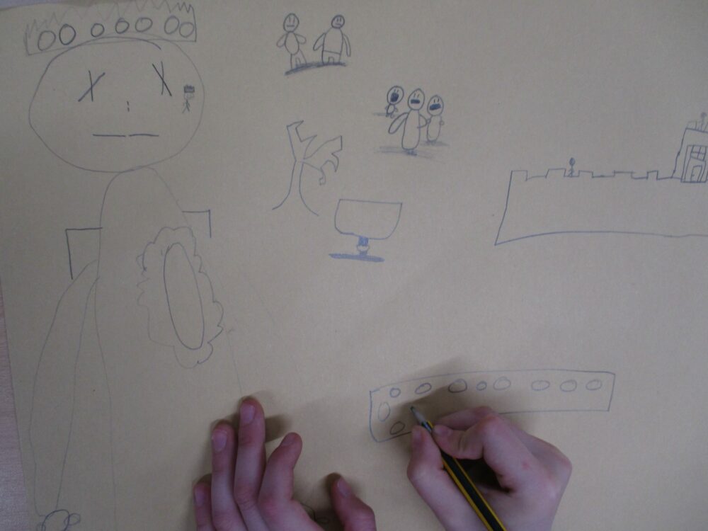 Adding detail to a drawn storyboard of Macbeth.