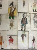 A wall display of costume designs for Bottom from A Midsummer Night's Dream.