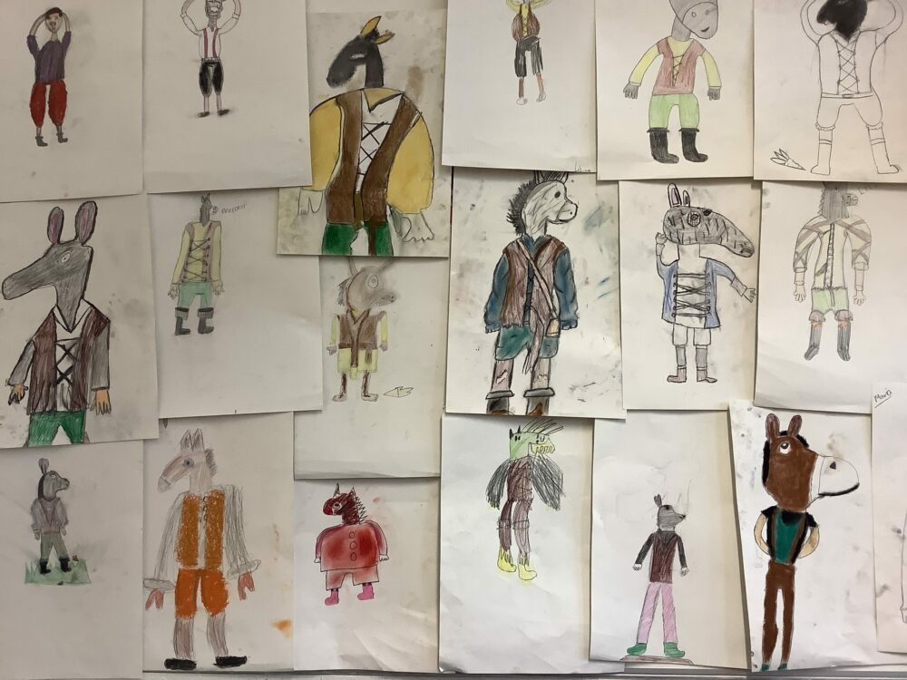 A wall display of costume designs for Bottom from A Midsummer Night's Dream.