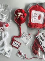 Four textile blood bags on display.