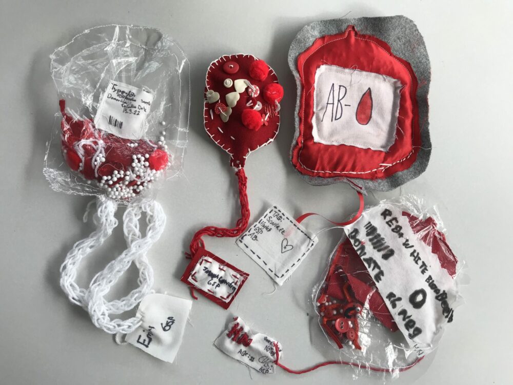 Four textile blood bags on display by Mandy Barrett