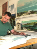 Artist Alej Ez working at his desk.