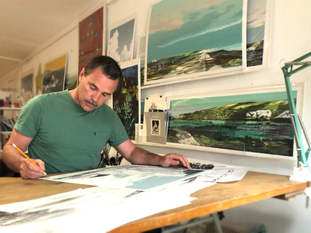 Artist Alej Ez working at his desk.