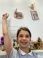 Elise Pointing At The Exhibition Wall by Natalie Deane