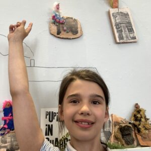 Elise Pointing At The Exhibition Wall by Natalie Deane