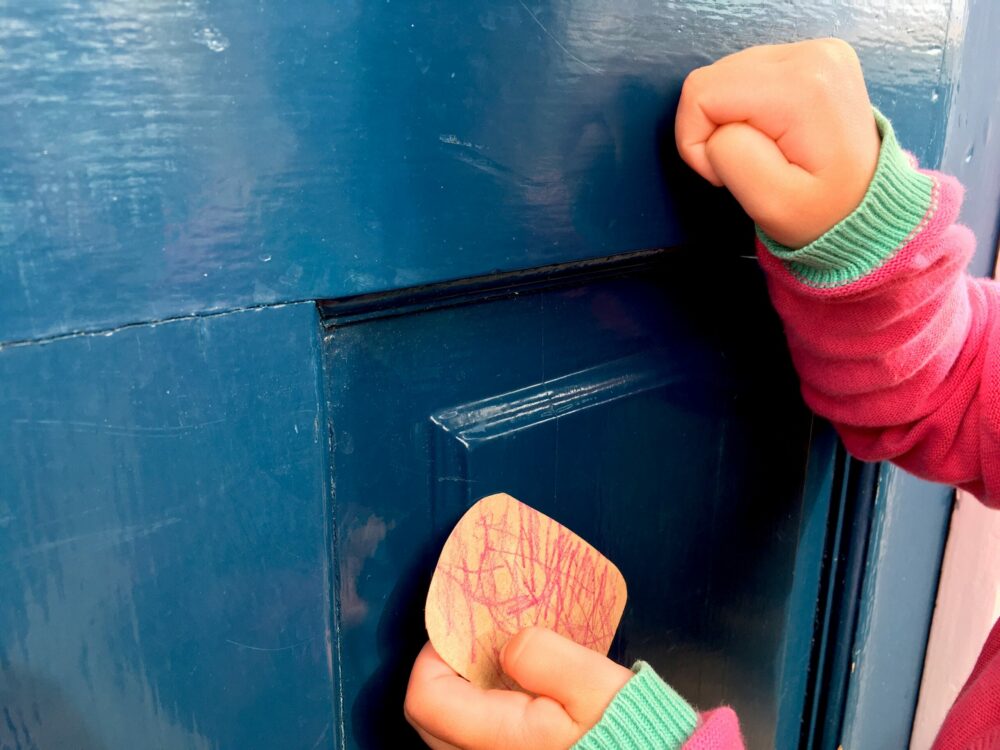 Knocking on a door to deliver a gift.