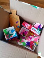 Filling a care box with cardboard items.