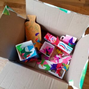 Filling a care box with cardboard items.